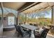 Covered patio area featuring a dining table, chairs, and views of the surrounding landscape at 27641 N 74Th St, Scottsdale, AZ 85266