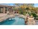 Beautiful backyard pool with stone accents, spa, waterfall, and outdoor seating for relaxation at 27641 N 74Th St, Scottsdale, AZ 85266