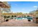 Luxury backyard pool features lush desert landscaping and a peaceful waterfall feature at 27641 N 74Th St, Scottsdale, AZ 85266