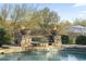 Close-up of pool with stone waterfall feature and fire bowls, perfect for evening swims at 27641 N 74Th St, Scottsdale, AZ 85266