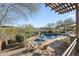 Inviting pool with spa, stone patio, and pergola, nestled in the desert landscape at 27641 N 74Th St, Scottsdale, AZ 85266