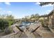 Beautiful backyard with stone patio and pool in a desert landscape. Features pergola and lounge chairs at 27641 N 74Th St, Scottsdale, AZ 85266