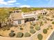 Aerial view of a house showcasing desert landscaping, a covered patio, and a well-maintained exterior at 27913 N Walnut Creek Rd, Rio Verde, AZ 85263