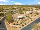 An aerial view of a single-Gathering home, showing the landscaping, desert plants and three-car driveway at 27913 N Walnut Creek Rd, Rio Verde, AZ 85263