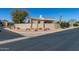 Beige home featuring an desert landscaping and block wall with a chimney on a bright day at 27913 N Walnut Creek Rd, Rio Verde, AZ 85263