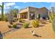 Expansive backyard with desert landscaping, covered patio, and outdoor seating area at 27913 N Walnut Creek Rd, Rio Verde, AZ 85263