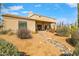 Desert landscaped backyard featuring a covered patio area with cacti and desert plants at 27913 N Walnut Creek Rd, Rio Verde, AZ 85263