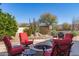 Backyard patio area with a firepit, outdoor seating, and desert landscaping at 27913 N Walnut Creek Rd, Rio Verde, AZ 85263