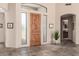 Bright foyer features a wooden door with sidelights, tile floors, and neutral decor at 27913 N Walnut Creek Rd, Rio Verde, AZ 85263