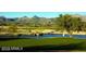 Lush green golf course with a water feature, mountains in the background, and a picturesque setting at 27913 N Walnut Creek Rd, Rio Verde, AZ 85263