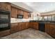 Well-equipped kitchen with wooden cabinets, built-in appliances, and tile backsplash at 27913 N Walnut Creek Rd, Rio Verde, AZ 85263