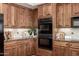 Kitchen featuring wooden cabinets, granite countertops, and modern appliances at 27913 N Walnut Creek Rd, Rio Verde, AZ 85263