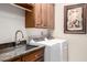 Laundry room features overhead cabinets, granite countertop and stainless steel sink at 27913 N Walnut Creek Rd, Rio Verde, AZ 85263