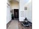 Elegant home entry with custom iron door, fountain, and decorative wall art at 2909 N 111Th Dr, Avondale, AZ 85392