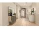 Inviting foyer featuring tiled floors, an ornate front door, and stylish console table at 2909 N 111Th Dr, Avondale, AZ 85392