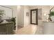 Inviting foyer featuring tiled floors, an ornate front door, and stylish console table at 2909 N 111Th Dr, Avondale, AZ 85392