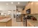 Beautiful kitchen featuring stainless steel appliances, ample cabinets, and an eat-in bar area at 2909 N 111Th Dr, Avondale, AZ 85392