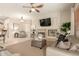 Inviting living room with a fireplace, TV, plush seating, and open access to other living areas at 2909 N 111Th Dr, Avondale, AZ 85392