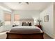 Bright main bedroom with ample natural light, features a tufted headboard, and cozy, neutral decor at 2909 N 111Th Dr, Avondale, AZ 85392