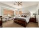 Serene main bedroom featuring a tufted headboard, neutral color palette, and abundant natural light at 2909 N 111Th Dr, Avondale, AZ 85392