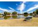 Lakeside bench with calm pond view surrounded by lush greenery, offering a serene and tranquil escape at 2909 N 111Th Dr, Avondale, AZ 85392