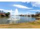 Scenic view of a large pond with multiple water fountains and residential properties in the background under a blue sky at 2909 N 111Th Dr, Avondale, AZ 85392