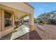 Covered back patio with desert landscaping featuring trees and plants at 29681 W Amelia Ave, Buckeye, AZ 85396