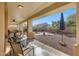 Comfortable covered back patio with dining set overlooking the serene desert landscape at 29681 W Amelia Ave, Buckeye, AZ 85396