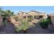 Spacious backyard with desert landscaping, covered patio, and decorative water feature at 29681 W Amelia Ave, Buckeye, AZ 85396