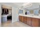 Bathroom featuring a double vanity, closet, and neutral color palette at 29681 W Amelia Ave, Buckeye, AZ 85396