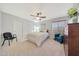 Cozy bedroom featuring a ceiling fan, closet, and neutral tones at 29681 W Amelia Ave, Buckeye, AZ 85396