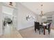 Open-concept dining room with a chandelier and carpet flooring at 29681 W Amelia Ave, Buckeye, AZ 85396