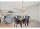 Dining room with a marble table, chandelier, and view to living room at 29681 W Amelia Ave, Buckeye, AZ 85396