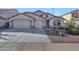 Charming single-story home featuring a three-car garage, well-manicured landscaping, and a welcoming entrance at 29681 W Amelia Ave, Buckeye, AZ 85396