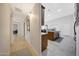 Hallway leading to kitchen with granite countertops, stainless steel appliances, and tile flooring at 29681 W Amelia Ave, Buckeye, AZ 85396