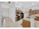 Well-lit kitchen with granite countertops, wooden cabinets, and black appliances, perfect for cooking at 29681 W Amelia Ave, Buckeye, AZ 85396