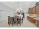 Spacious kitchen featuring wooden cabinets, granite countertops, a breakfast bar, and modern stainless steel appliances at 29681 W Amelia Ave, Buckeye, AZ 85396