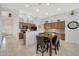 Open kitchen and dining area featuring wooden cabinets, granite countertops, and a decorative backsplash at 29681 W Amelia Ave, Buckeye, AZ 85396