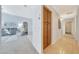 Bright living room showcasing a gray sofa and recliner adjacent to the hallway at 29681 W Amelia Ave, Buckeye, AZ 85396