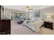 Inviting main bedroom with a bay window, chaise lounge, and neutral decor at 29681 W Amelia Ave, Buckeye, AZ 85396