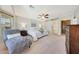 Comfortable bedroom with a bay window, chaise lounge, and light gray color scheme at 29681 W Amelia Ave, Buckeye, AZ 85396