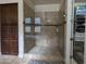 Tiled walk-in shower featuring a built-in seat and glass enclosure, plus convenient shelving at 3212 E Constance Way, Phoenix, AZ 85042