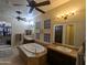 Elegant bathroom featuring a soaking tub, double vanity, and unique glass block windows at 3212 E Constance Way, Phoenix, AZ 85042