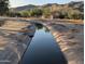 Scenic canal view with clear water, reflecting the natural beauty and tranquil environment at 3212 E Constance Way, Phoenix, AZ 85042