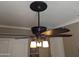 Close-up of a decorative ceiling fan with ornate detailing and three frosted lights at 3212 E Constance Way, Phoenix, AZ 85042