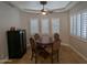 Charming dining room with a tray ceiling, plantation shutters, and a modern wine fridge at 3212 E Constance Way, Phoenix, AZ 85042