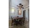 A dining room with tile floors, large portraits, and an ornamental ceiling fan at 3212 E Constance Way, Phoenix, AZ 85042