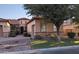 A charming home exterior featuring a stone base, desert landscaping, and a tiled roof at 3212 E Constance Way, Phoenix, AZ 85042