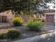 Home exterior showcasing desert landscaping, a brick driveway, and a three-car garage at 3212 E Constance Way, Phoenix, AZ 85042