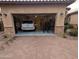 Attached garage with epoxy flooring, car, workout area, and stone accents that complement the home's exterior at 3212 E Constance Way, Phoenix, AZ 85042